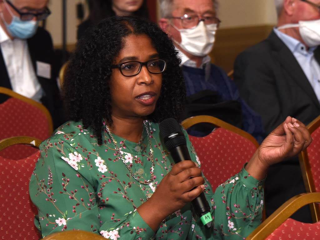 Woman speaking into microphone at an RCPI event